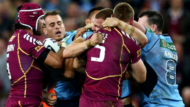 Origin fight: Trent Merrin of the Blues and Brent Tate of the Maroons clash during Origin II.