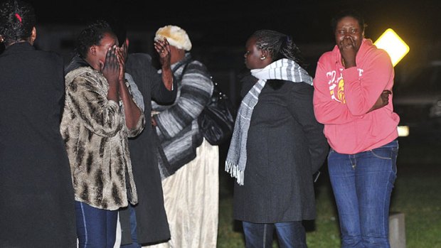 Shock ... Family members weep at the scene of the fatal attack.