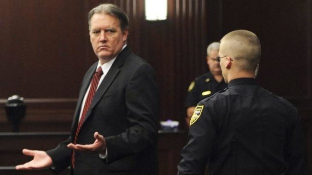 Guilty ... Michael Dunn raises his hands in disbelief as he looks toward his parents after the verdicts were announced in his trial in Jacksonville, Florida.