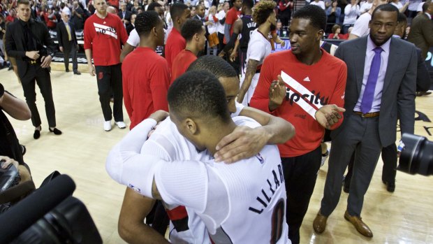 Moving on: McCollum embraces Damian Lillard after the Blazers clinched the series.