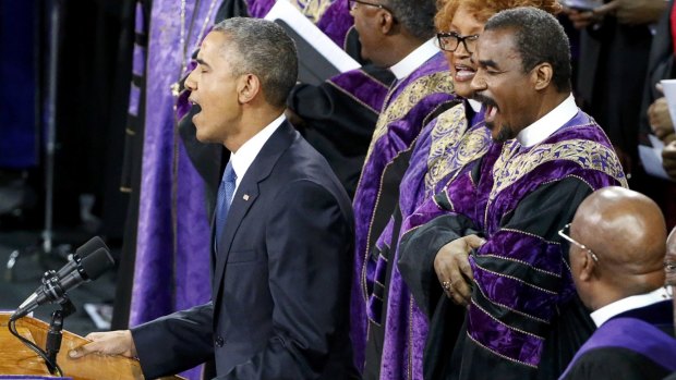 Barack Obama leads mourners at Reverend Clementa Pinckney's funeral in singing Amazing Grace in June. 