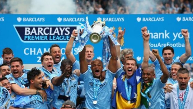 Vincent Kompany lifts the Premier League trophy following Manchester City's 2-0 win over West Ham at Etihad Stadium on Sunday.