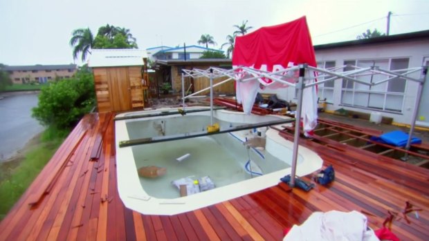 BEFORE: The canal levels were rising at Aaron and Dee's Gold Coast home during the cyclone.
