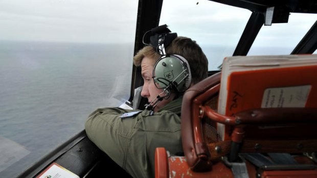 Flying Officer Benjamin Hepworth searches from a Royal Australian Airforce AP-3C Orion from Pearce Airforce Base during a search mission for possible MH370 debris on March 21, 2014 in Perth.
