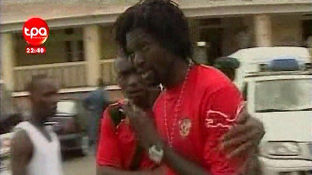 A video grab from Angolan TV shows Emmanuel Adebayor (R) of Manchester City being comforted outside a hospital in Cabinda.