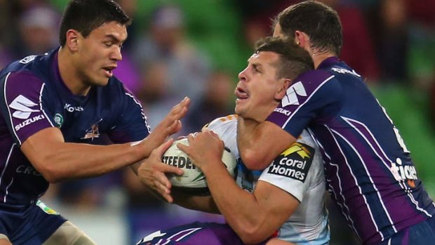 Handful: the Titans Greg Bird took some heavy treatment from the Storm.