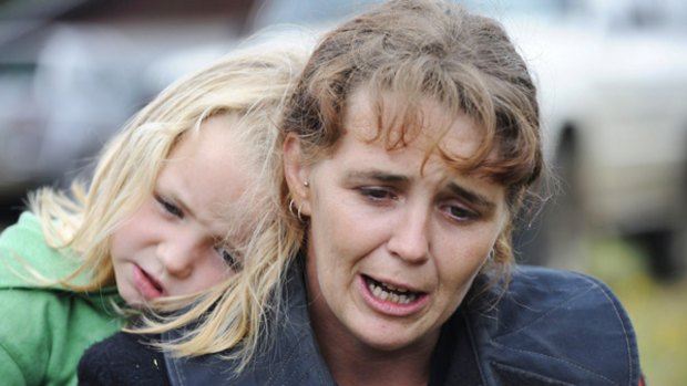 Shell shocked: Heather Perring and daughter Phoebe huddle outside the Kinglake CFA shed. "There was just no warning, no nothing," she says. "It just happened like there was going to be no tomorrow."
