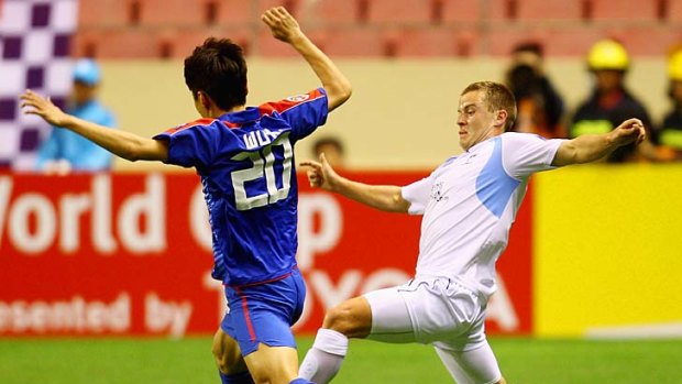 Over the top . . . Scott Jamieson competes for the ball during Sydney FC's ACL win in Shanghai on Tuesday night.