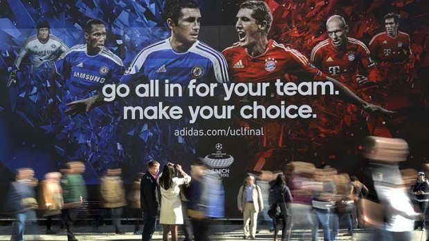 People walk past an advertisement for the Champions League final in Munich.