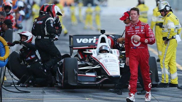 Scott Dixon of New Zealand walks away from Will Power of Australia after being knocked out of the IZOD IndyCar Series Baltimore Grand Prix on Sunday.