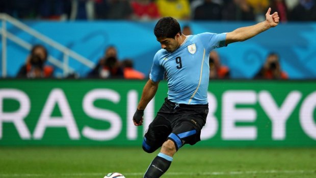 Deadly ... Luis Suarez of Uruguay shoots and scores his team's second goal.