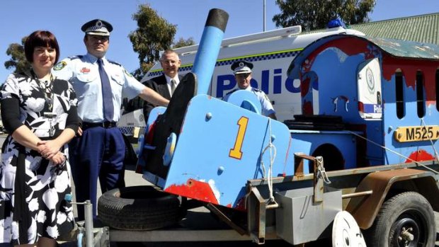 Thomas the Tank Engine is welcomed back to safety by Goulburn Council's Julianne Salway, acting Local Area Commander Evan Quarmby, Mayor Geoff Kettle and Goulburn Police crime manager Detective Inspector Chad Gillies.