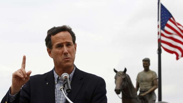 Ride with me ... Republican presidential candidate Rick Santorum speaks in front of a statue of Ronald Reagan in the former president's home town of Dixon, Illinois.