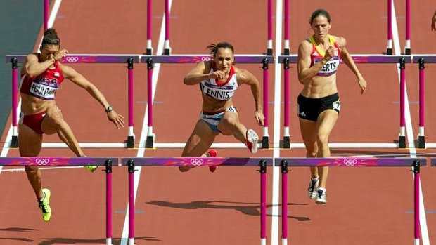 Jessica Ennis (centre) runs the fastest ever heptathlon 100 metre hurdles on day one of the ahletics at the Olympic Stadium in London.