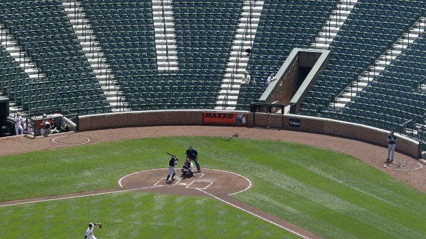 Baltimore Orioles starting pitcher Ubaldo Jimenez throws to Chicago White Sox's Adam Eaton in the MLB's first-ever spectator-free baseball game at Oriole Park, Camden Yards in Baltimore. 