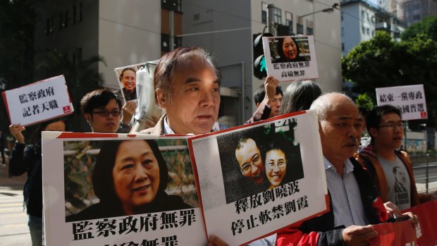 Human rights organisations say the treatment of Anastasia Lin is an extension of China's silencing of critics at home. Here a protester in Hong Kong carries the images of journalist Gao Yu, Nobel laureate Liu Xiaobo and his wife Liu Xia, all of whom are detained in China.