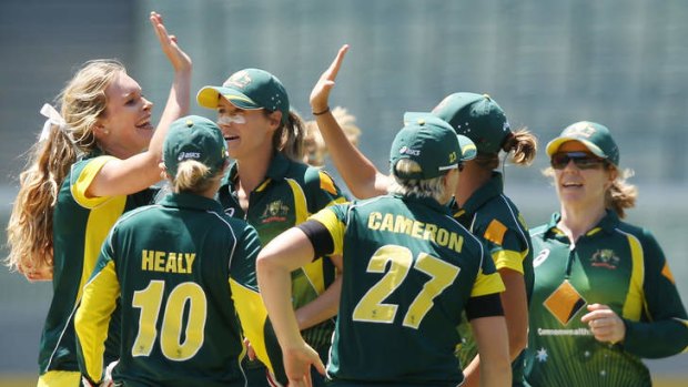 Moral victory: The Australian team celebrates the dismissal of England's Charlotte Edwards on Friday.