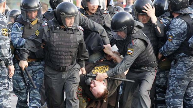 Russian police drag away an anti-Putin protester on May 6.