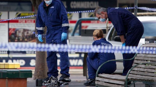 Police inspect the Sunshine shopping area where a mother of four was stabbed to death.