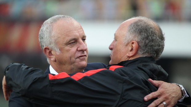 Respect: Sydney FC coach Graham Arnold and his Guangzhou Evergrande counterpart Luiz Felipe Scolari embrace during the game in Guangzhou on May 3 .