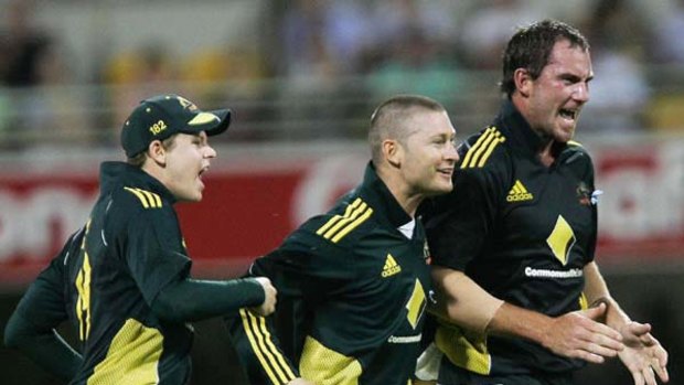 Michael Clarke celebrates the wicket of Kevin Pietersen with John Hastings and Steve Smith.