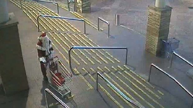 Wanted man ... a person dressed as Santa stole money from an office in a shopping centre.