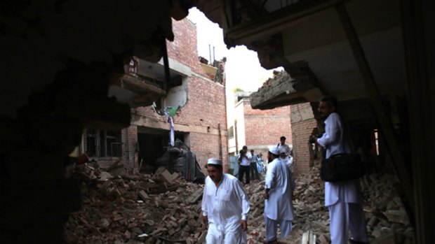 People walk through rubble after a car bomb attack in Peshawar last week.