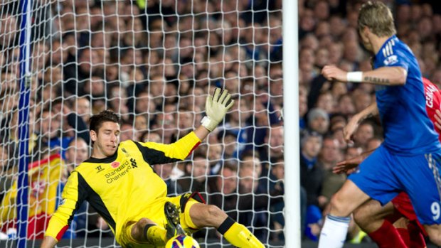 Liverpool's Brad Jones (left) makes a save from Chelsea's Fernando Torres (right) at Stamford Bridge.
