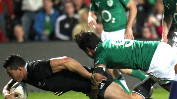 Try ... Sonny Bill Williams of New Zealand scores as he is tackled by Conor Murray of Ireland.