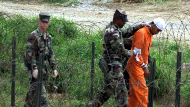 Interrogated ... military police with a prisoner at camp X-ray at Guantanamo Bay.