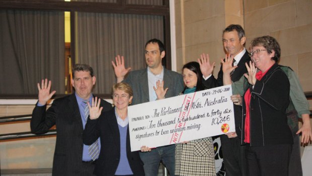 Members of Parliament are delivering an oversized cheque of over 10,000 signatures. Photo: Jake Cortez