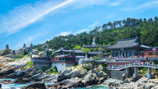 Haedong Yonggungsa Temple sits upon a cliff overlooking the East Sea in Busan, South Korea.