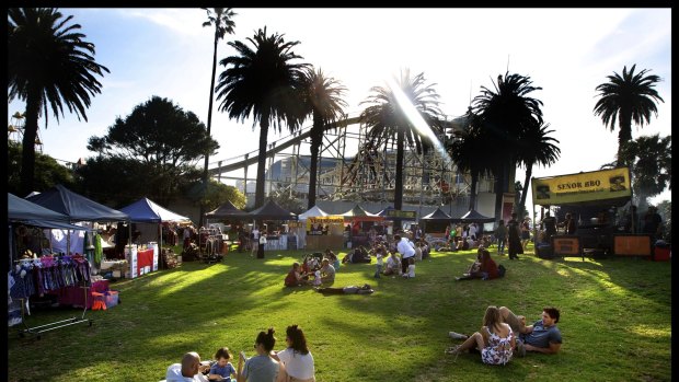 Melburnians relax on the grass in St Kilda.