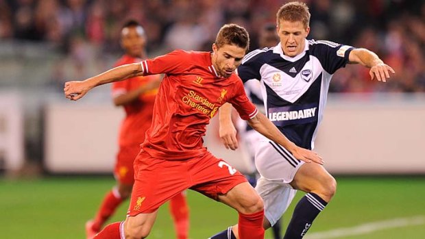 Liverpool's Fabio Borini chased by Victory's Adrian Leijer at the MCG, 24th July 2013.
