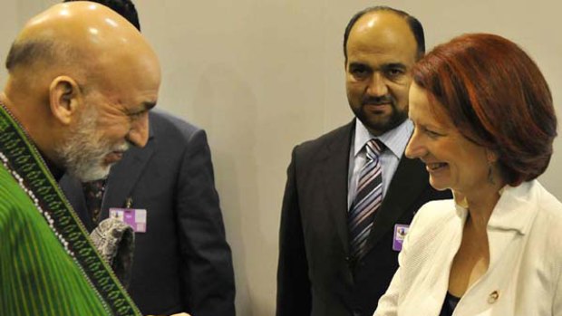 Afghan President Hamid Karzai meets Prime Minister Julia Gillard in Lisbon, where the two are attending the NATO summit.