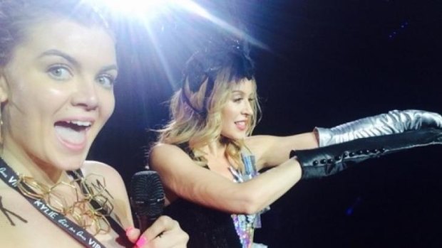 Minogue slid off a glove to take a selfie with the young fan.