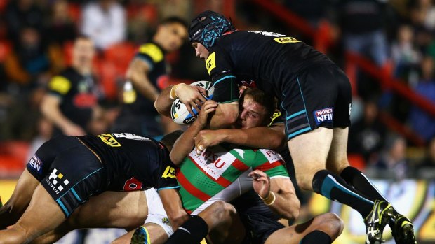 Going nowhere: George Burgess of the Rabbitohs is swamped by Penrith defenders. 