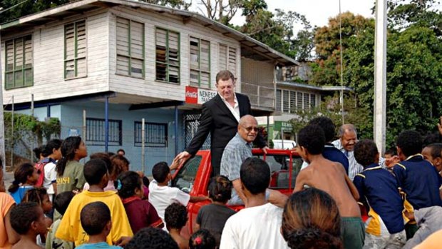 Hit ... Phil Gould is mobbed while in PNG to investigate its belief that having a side in the NRL will help unite its 800 tribes and counter a raft of social problems.