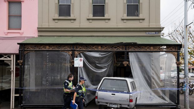 Police inspect the ute that smashed into Carlton's North's Paragon Cafe in June last year. 