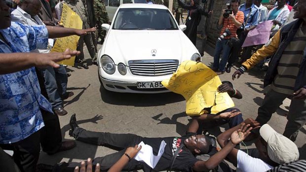 Laying down the law ... a protester blocks a road near the Kenyan Parliament in Nairobi after MPs raised taxes to award themselves a huge bonus payment.
