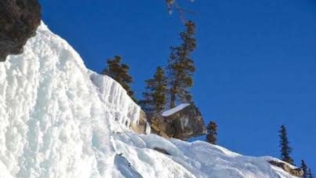 Climbing a frozen waterfall in a Jasper National Park.