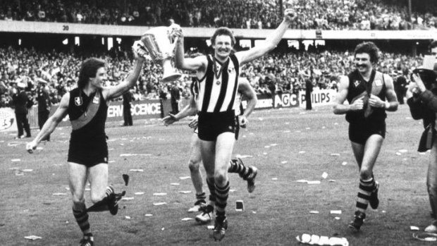 Richmond players Geoff Raines, Michael Roach (wearing a Collingwood guernsey) and Mick Malthouse after their grand final series win in 1980. 