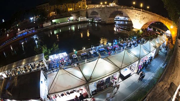 Temporary shops and cafes along the banks of the River Tiber during the happening "Along the Tiber in Rome ... a river of culture" for the summer event in central Rome.