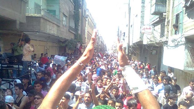 Demonstrators march through the streets after Friday prayers in the Hajar Al Asswad in Damascus on June 24.