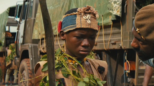 Idris Elba and Abraham Attah (left) in <i>Beasts of No Nation</i>.