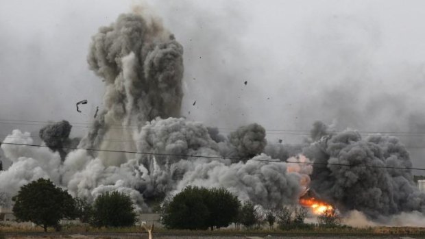 Field of fire: Smoke, debris and flames rise in Kobane after an air strike by the US-led coalition.
