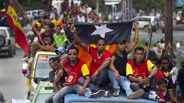 "Shifting from authoritarian rule to democracy brings its own challenges" ... Fretilin supporters parade down the streets of Dili, Timor-Leste.