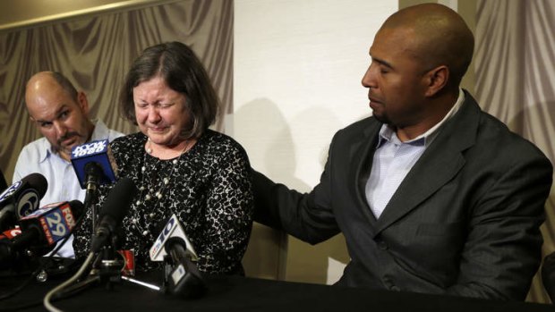 Enduring pain: Former NFL player Dorsey Levens comforts Mary Ann Easterling, the widow of former NFL player Ray Easterling, after a hearing into concussion-related brain injuries.