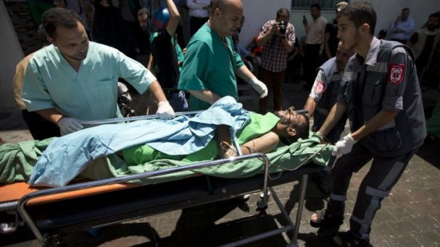 A Palestinian man, wounded following an Israeli military strike, arrives at the hospital in Rafah in the southern Gaza Strip.