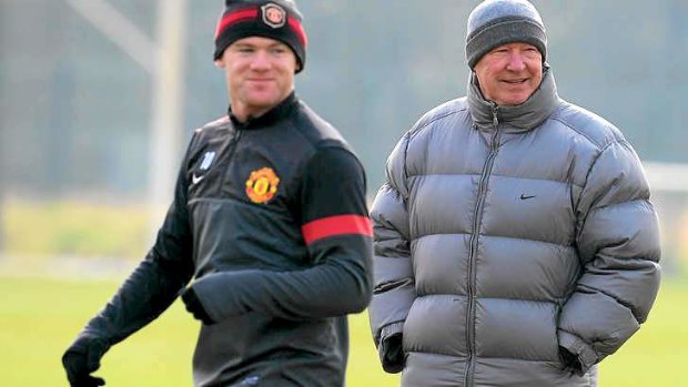 The cold shoulder ... Manchester United manager Alex Ferguson forward Wayne Rooney at training earlier this week.